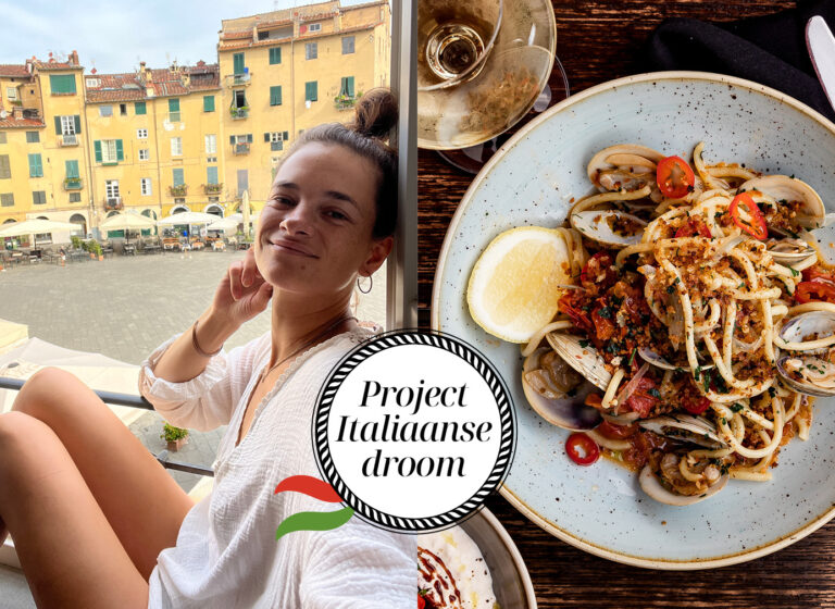 Liesbeth lachend in raamkozijn in italiaans appartement met pasta en witte wijn