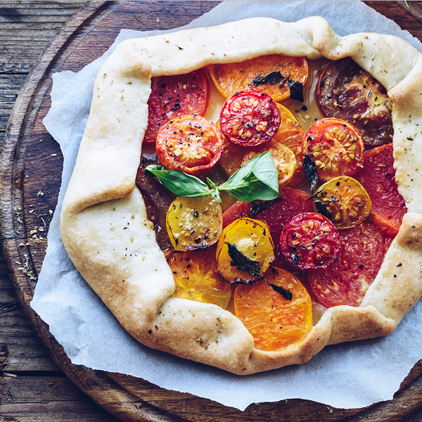 Savory galette with fresh colorful tomatoes and basil